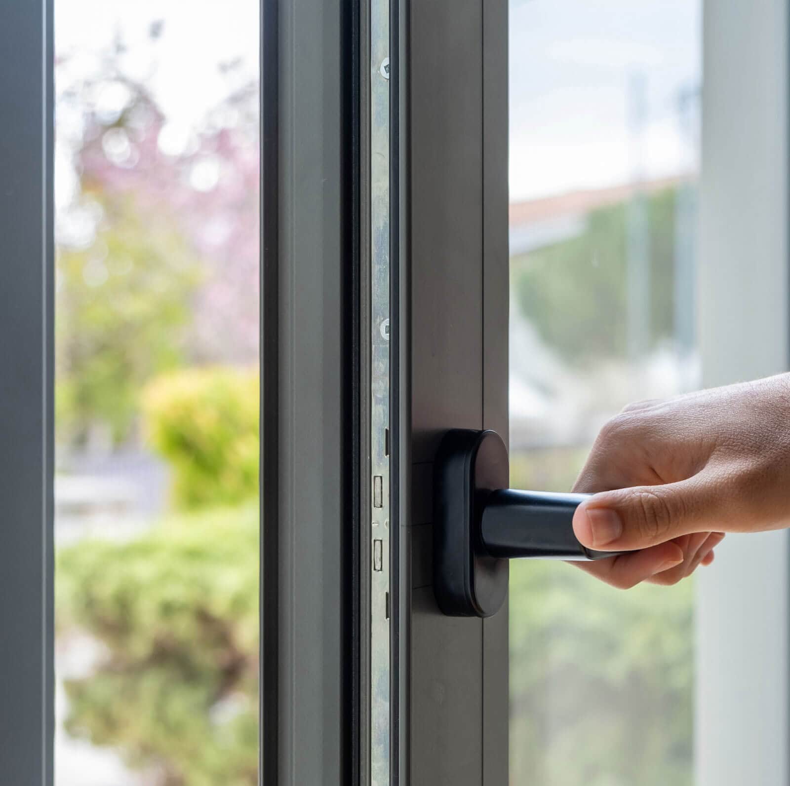 Aluminum window frame detail male hand opens