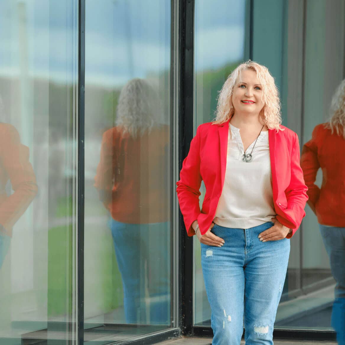 Senior woman standing near the tempered glass wall